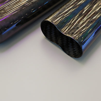 Black carbon fiber cigar case on a reflective metallic surface