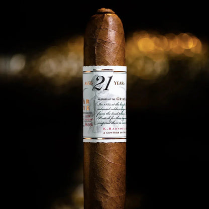 Cigar with a label reading '21' against a dark background