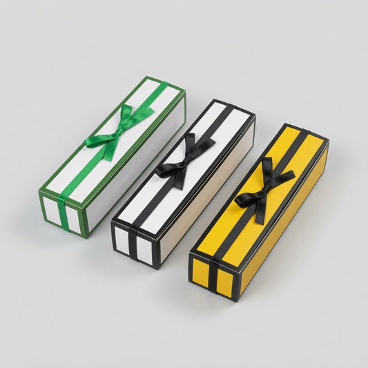 Three long rectangular gift boxes with striped patterns, tied with ribbon bows, arranged diagonally on a light gray background. The boxes are white with green stripes and a green ribbon, white with black stripes and a black ribbon, and yellow with black stripes and a black ribbon.