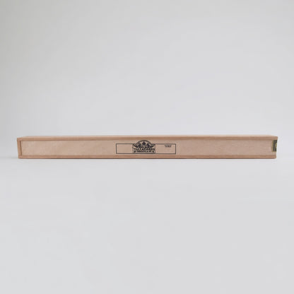 A long, narrow light wood cigar box with a black printed logo in the center, shown horizontally against a plain light gray background.