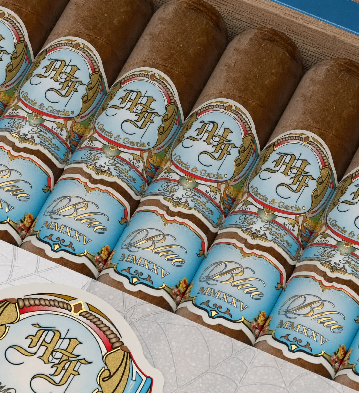 Close-up of several cigars in a wooden box, each wrapped with a light blue and gold label reading Blue Majesty and Havana.