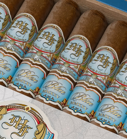 Close-up of several cigars in a wooden box, each wrapped with a light blue and gold label reading Blue Majesty and Havana.