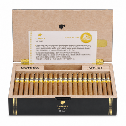 A Cohiba Cuban year of rabbit Short cigar box shown open, with multiple cigars arranged in rows inside. The box is black on the front with gold trim and a gold-toned interior lid, and a branded insert card is visible in the lid.