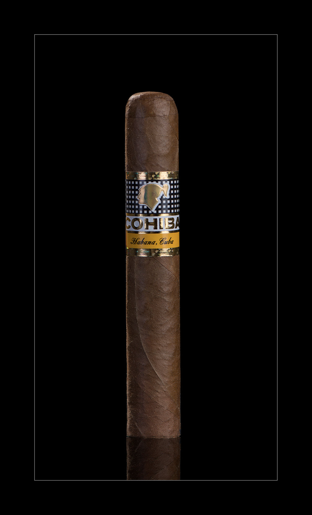 A single brown cigar with a patterned black and gold band reading 'COCHILAS' and 'Maderne Cuba', centered on a black background.