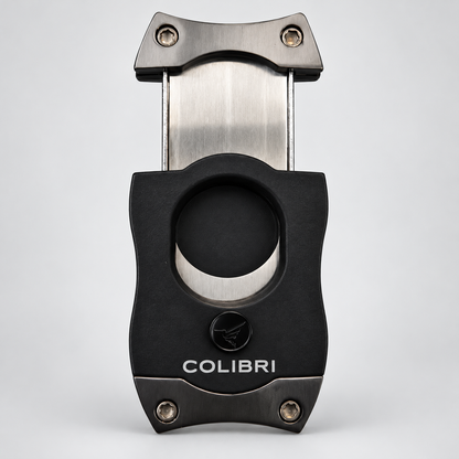 A black and stainless steel cigar cutter with the brand name 'COLIBRI' printed on the front, set against a light gray background.