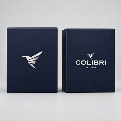 Two dark navy blue rectangular boxes standing upright on a light gray studio background. The left box shows a white bird logo, and the right box shows the white COLIBRI logo with 'EST.