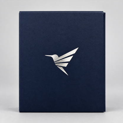 A dark navy blue textured box with a metallic silver hummingbird logo on the front, set against a neutral light gray background.