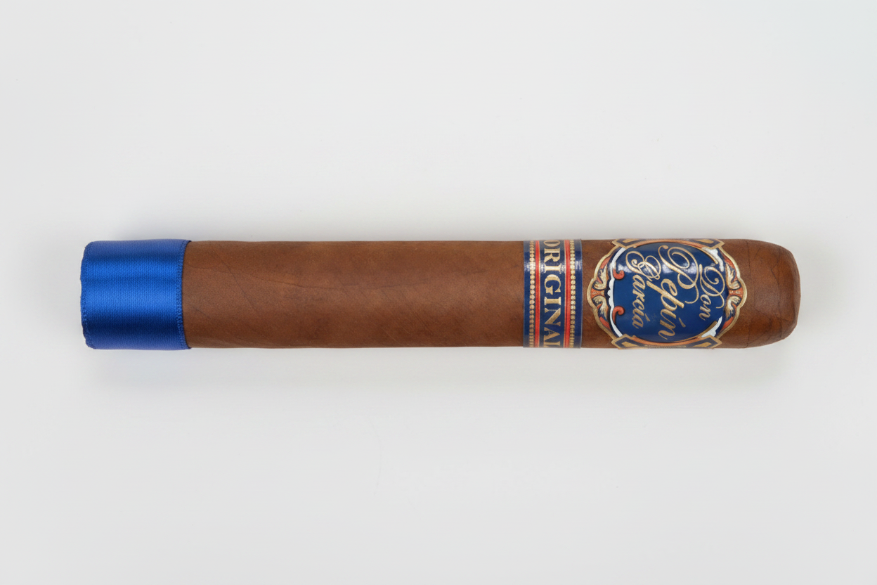 A single brown cigar shown horizontally against a white background, featuring a blue and gold band with the text 'Pinaud Original' and a blue tip.