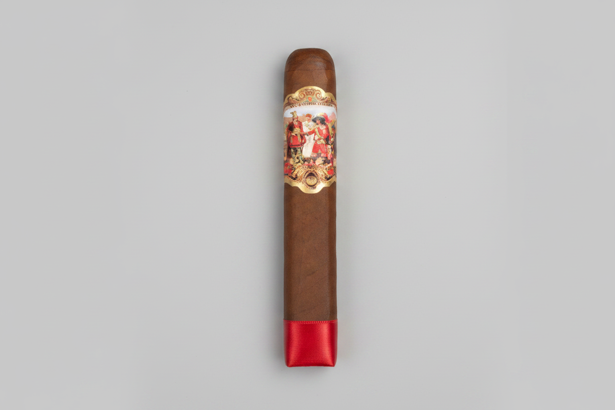 A single brown cigar with a red satin band on one end and a large ornate gold, red, and white label featuring the brand name 'Pabellon' on the side, shown against a plain white background.