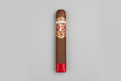 A single brown cigar with a red satin band on one end and a large ornate gold, red, and white label featuring the brand name 'Pabellon' on the side, shown against a plain white background.
