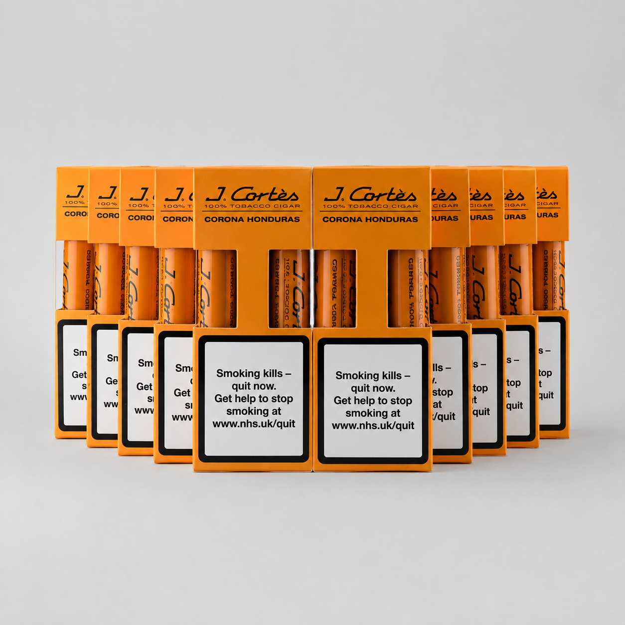 A row of orange J. Cortés Corona Honourias cigarette packs arranged in a fan shape on a light gray background, with prominent smoking-health warning labels on the front.