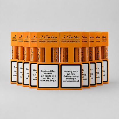 A row of orange J. Cortés Corona Honourias cigarette packs arranged in a fan shape on a light gray background, with prominent smoking-health warning labels on the front.