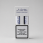 A white J. Cortés Corona Dominican tobacco packaging box on a light gray background, showing two rolled tobacco papers and a prominent smoking-health warning label on the front.