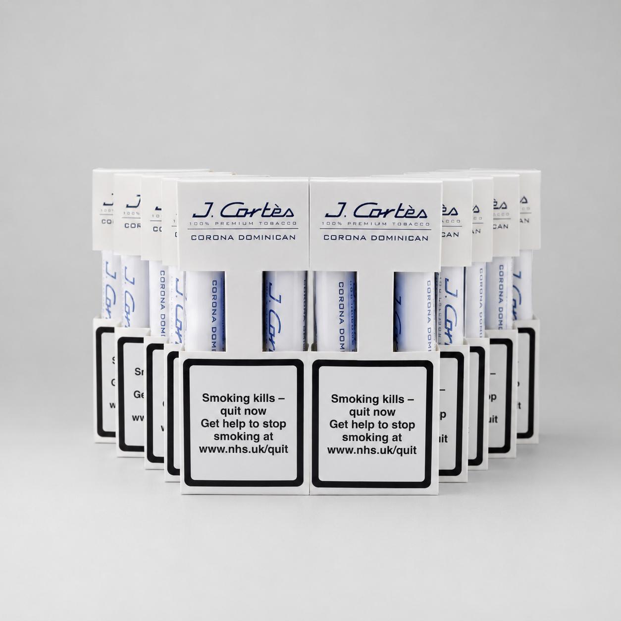 A row of J. Cartes Corona DominicaN cigarette packs arranged in a fan shape on a light gray background.