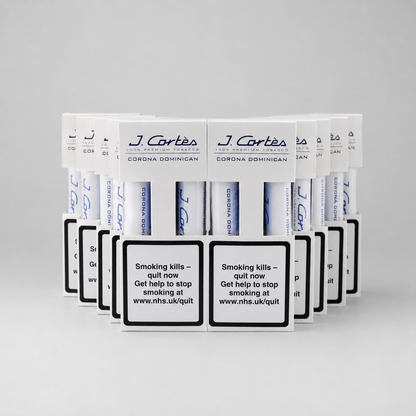 A row of J. Cartes Corona DominicaN cigarette packs arranged in a fan shape on a light gray background.