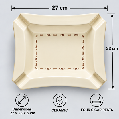 Top-down view of a square ceramic ashtray with dimension markers showing 27 cm by 23 cm, plus icons indicating it is ceramic and has four cigar rests, on a light gray background.