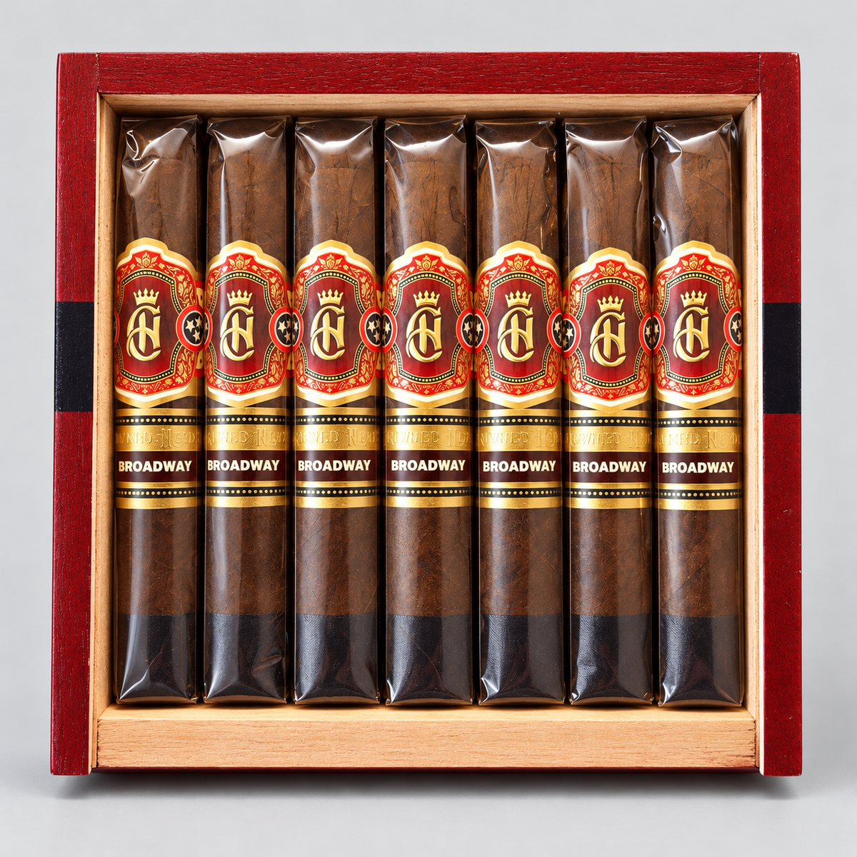 Eight cigars in clear plastic sleeves with red, gold, and black labels reading 'BROADWAY' and a large 'BA' logo, arranged inside an open reddish-brown wooden presentation box on a light gray background.