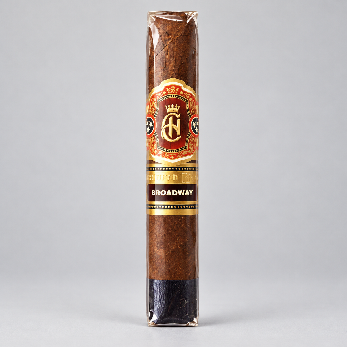 A single wrapped cigar standing upright on a light gray background. The cigar has a brown textured wrapper with a decorative paper label featuring a gold and red crest and the text 'AF' and 'BROADWAY'.