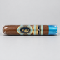 A single wrapped cigar on a light gray background. The cigar is brown with a decorative label featuring gold, blue, and black details, and a bright blue band at the end.