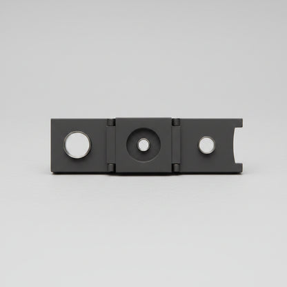 Black metal Cigar cutter on a wooden surface