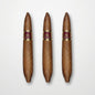 Three brown cigars with gold and burgundy bands labeled 'Cuaba.