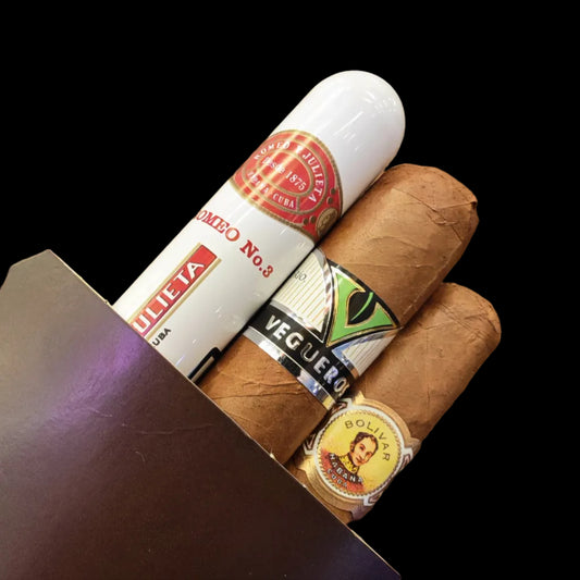 Three cigars with visible labels on a wooden surface