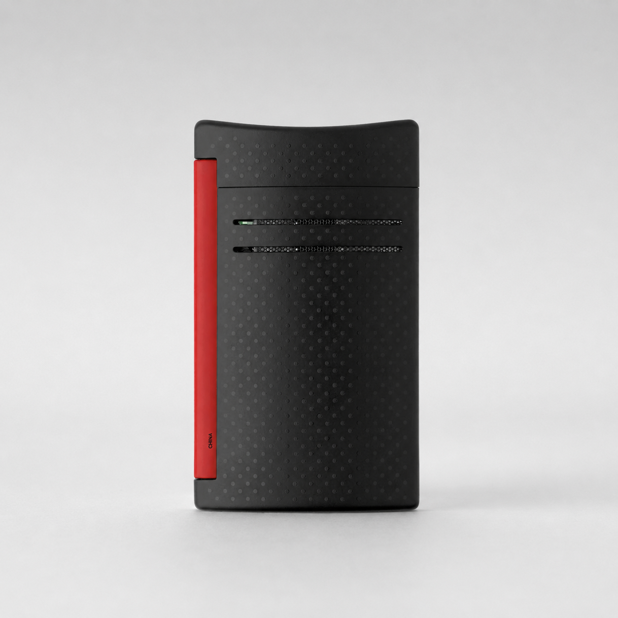 A black textured rectangular electronic device with a vertical red accent strip on the left side, shown against a light gray studio background.