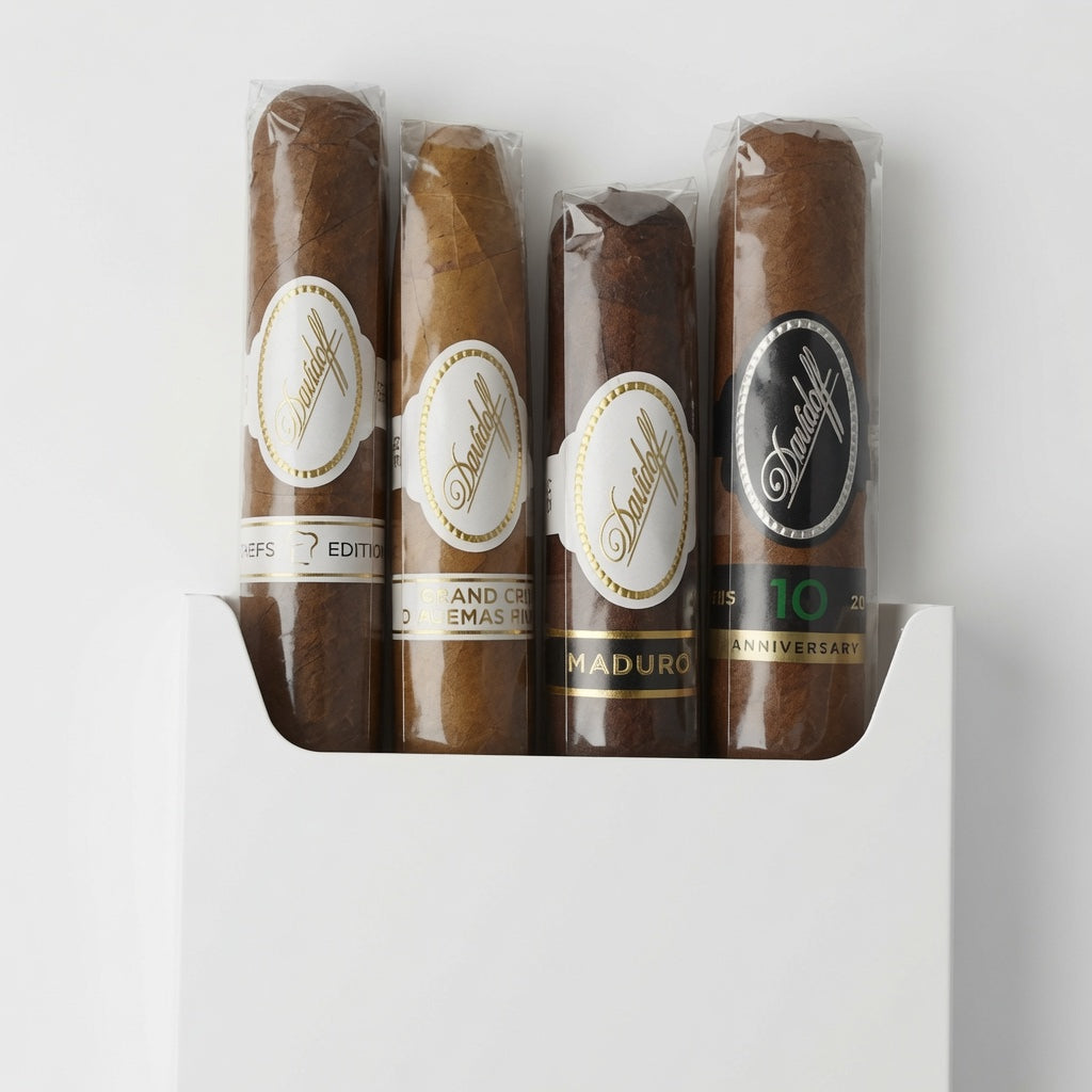 Four Davidoff cigars in clear plastic wrappers with round paper bands, arranged vertically in a white box on a white background. The bands show the brand name 'Davidoff' in script.