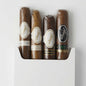 Four Davidoff cigars in clear plastic wrappers with round paper bands, arranged vertically in a white box on a white background. The bands show the brand name 'Davidoff' in script.