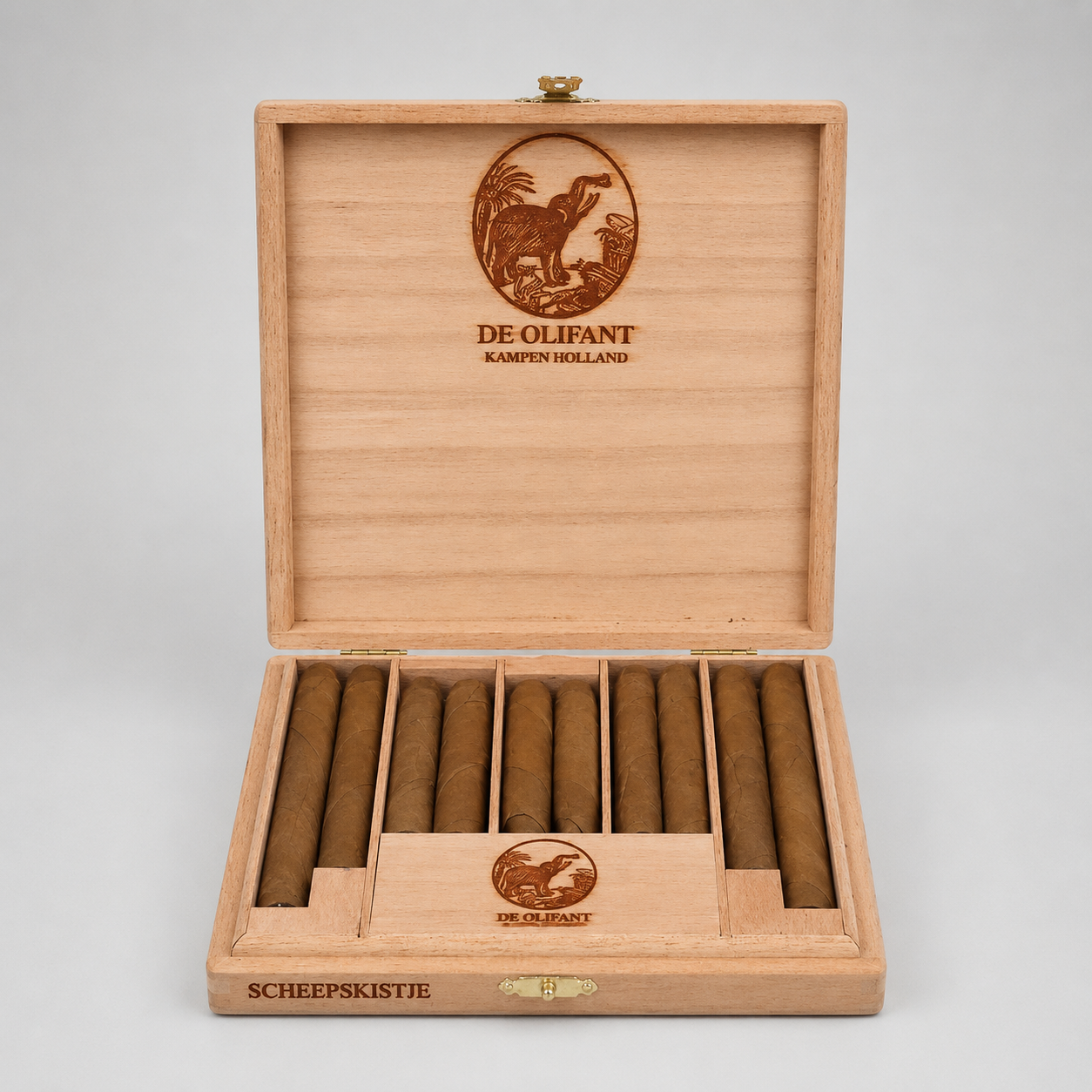 An open wooden cigar box on a light gray background, containing ten brown cigars. The box is made of light natural wood with engraved branding for De Olifant, including a bird logo and the text 'KAMPION HOLLAND' on the inner lid, and 'SCHEEPSKISTJE' on the front panel.