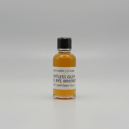 Small bottle of Diftless Glen Rye Whiskey with a black cap on a white background
