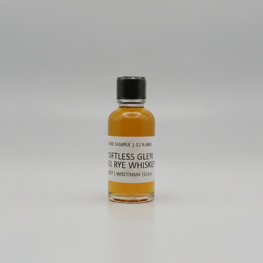 Small bottle of Diftless Glen Rye Whiskey with a black cap on a white background