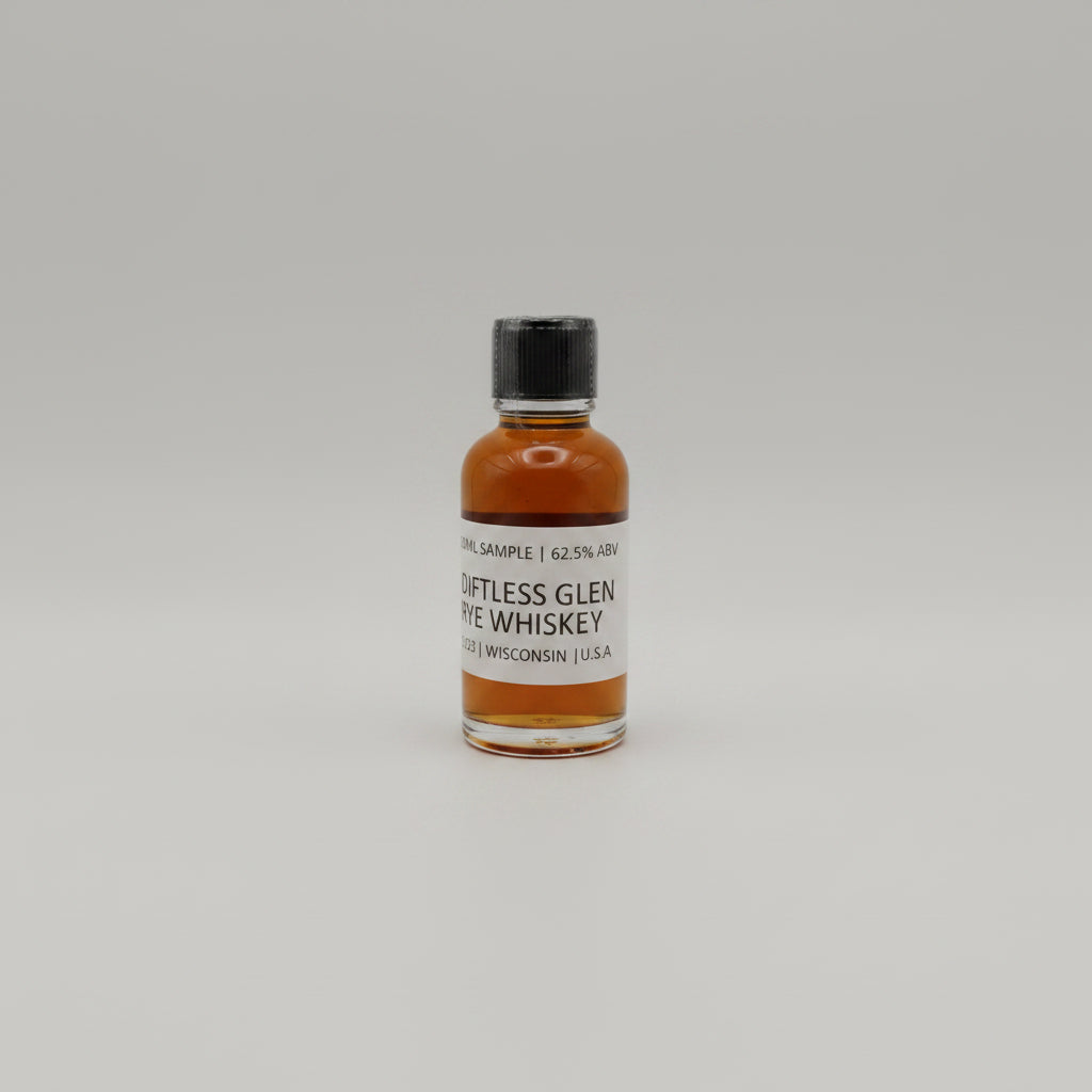 Small bottle of Diftless glen Whiskey on a light gray background