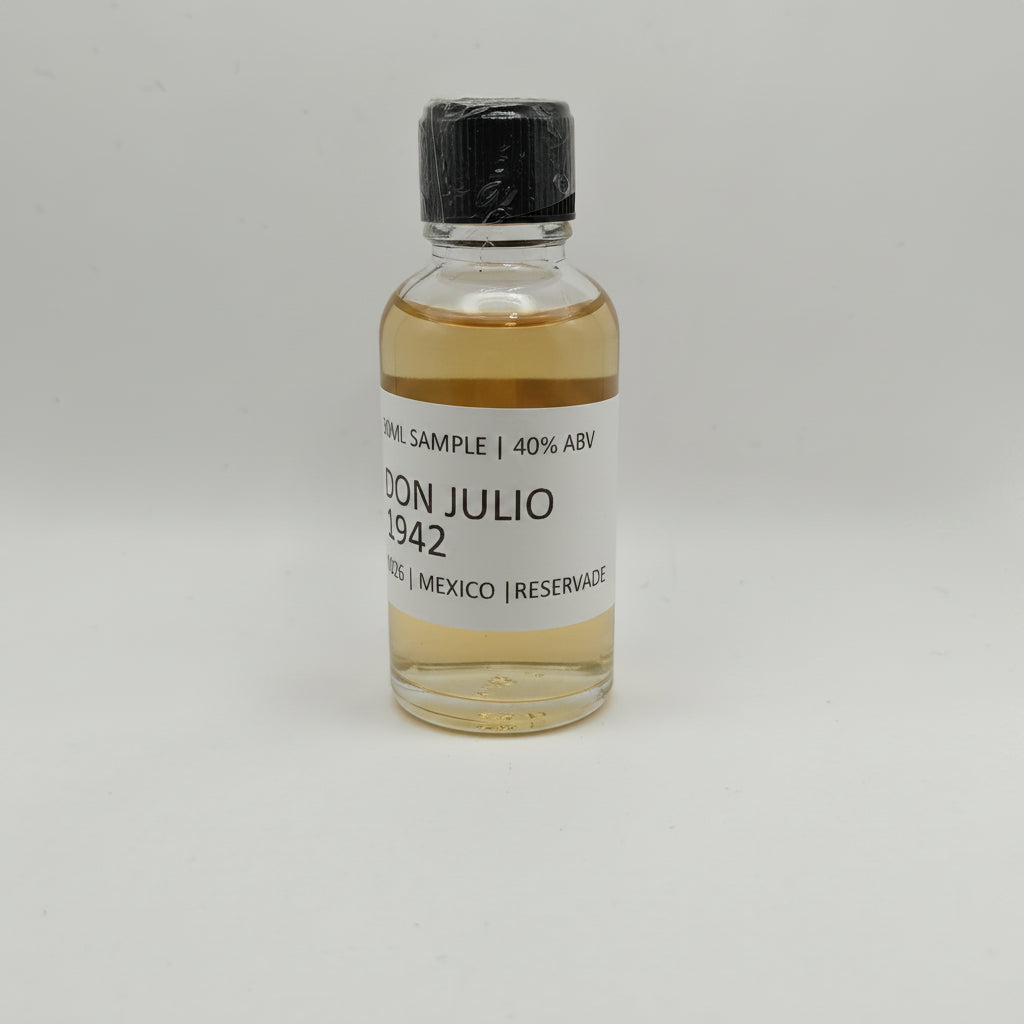 Small bottle of Don Julio 1942 on a gray background
