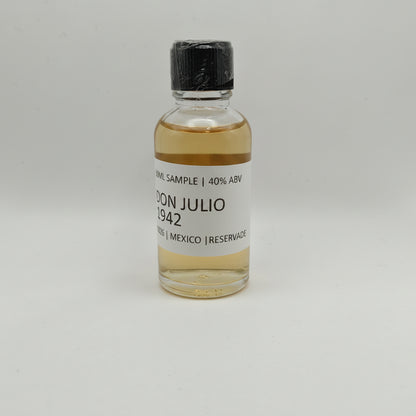 Small bottle of Don Julio 1942 on a gray background