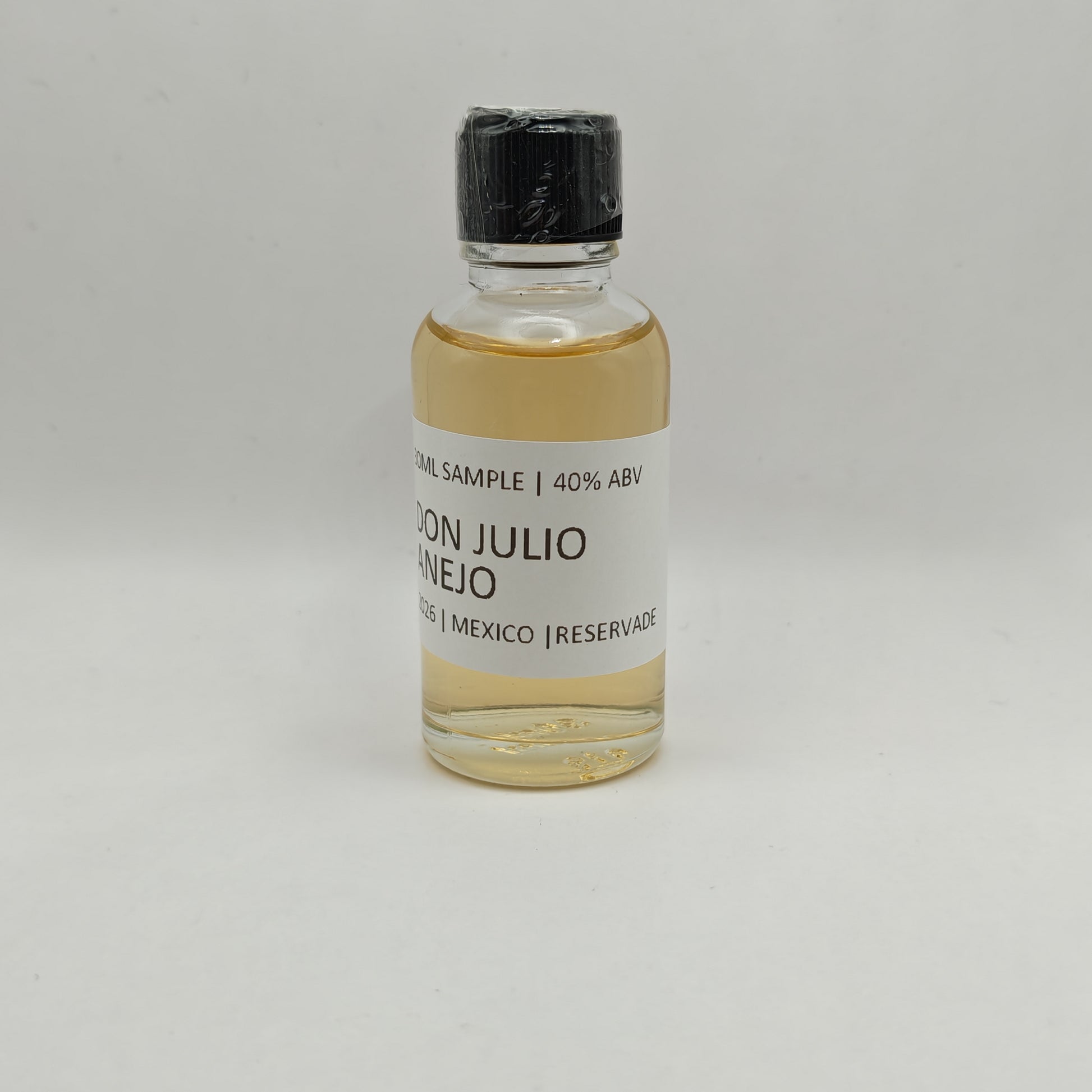 Small bottle of Don Julio Anejo on a gray background