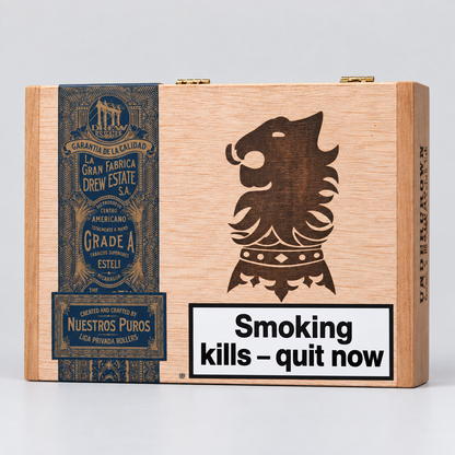 A wooden cigar box with a natural light wood finish, featuring a dark brown engraved lion head emblem, a dark blue vintage-style label on the left, and a white warning label that reads 'Smoking kills - quit now'.
