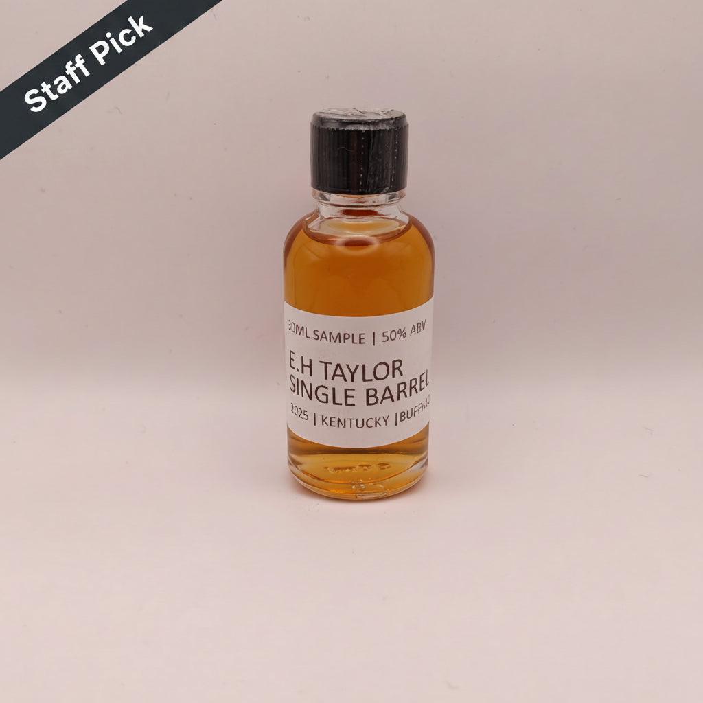 Bottle of E.H. Taylor Single Barrel whiskey on a beige background