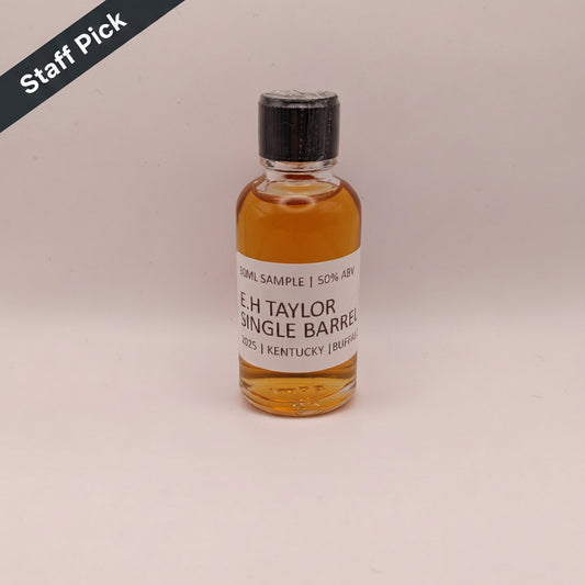 Bottle of E.H. Taylor Single Barrel whiskey on a beige background