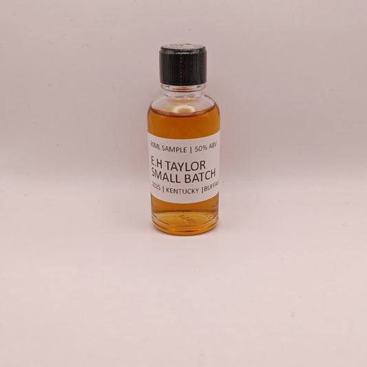 Small bottle of E.H. Taylor Small Batch whiskey on a beige background