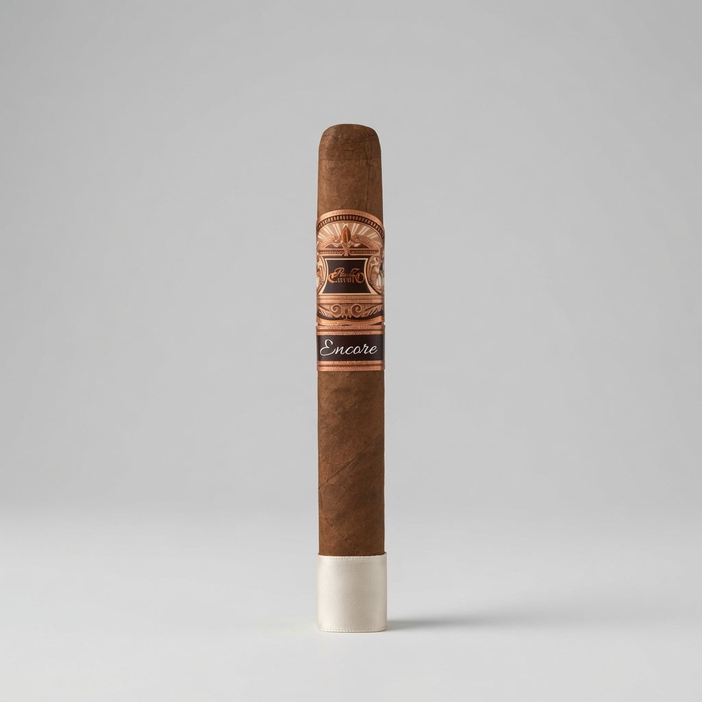 A single brown cigar standing upright on a white base against a light gray studio background. The band around the middle features a decorative gold and black design with the brand name 'Encore' visible on a dark band section near the bottom.