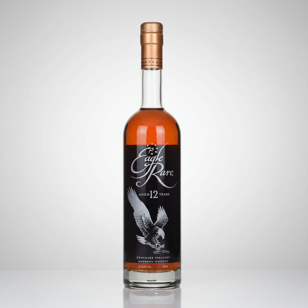 A bottle of Eagle Rare 12 Year Old BOURBON Whisky on a white background with a subtle reflection. The bottle is filled with amber-colored whisky and features a black label with a white eagle illustration and the brand name 'Eagle Rare' in white script.