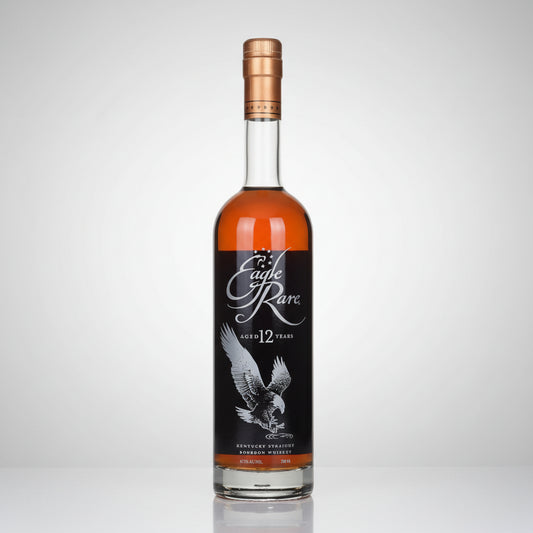 A bottle of Eagle Rare 12 Year Old BOURBON Whisky on a white background with a subtle reflection. The bottle is filled with amber-colored whisky and features a black label with a white eagle illustration and the brand name 'Eagle Rare' in white script.
