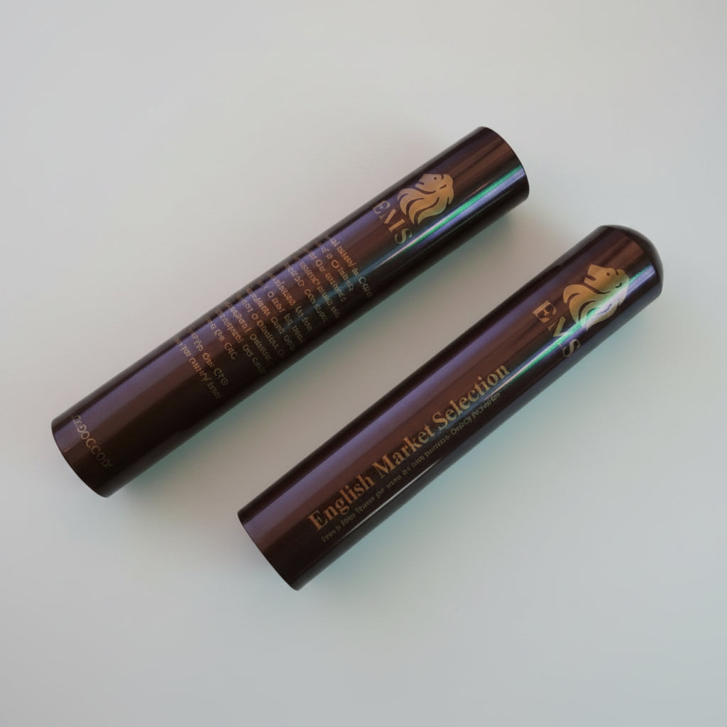 Two brown cylindrical Habanos EMS English Market Selection tubo - Tubes - Aluminium with a EMS logo on a White background surface