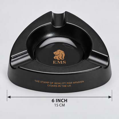 Black triangular cigar ashtray with gold EMS lion logo and text, shown on a light gray background with a 6-inch (15 cm) width measurement overlay.