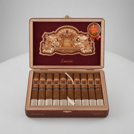 An open wooden cigar box displaying ten cigars inside, with a red velvet interior and an ornate gold-toned emblem on the lid. A red and gold 'Cigar of the Year 2018' award seal is attached to the upper right.