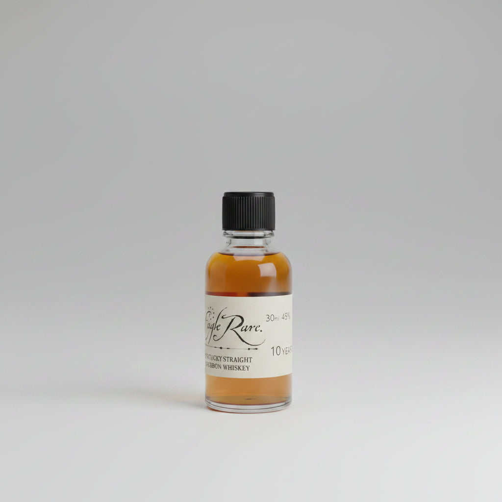 Small bottle of whiskey labeled 'Eagle Rare' on a bar counter with a blurred bar background
