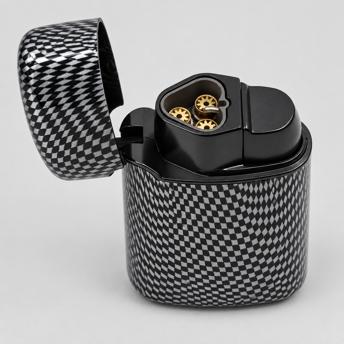A black and white checkered carbon fiber lighter shown open, revealing gold-toned ignition components inside, set against a neutral light gray background.