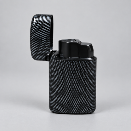 A carbon fiber patterned lighter with a black ignition mechanism, shown open against a neutral light gray background.