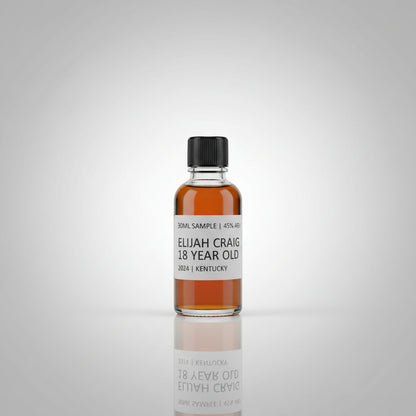 Bottle of Elijah Craig 18 Year Old bourbon on a reflective surface with blurred background